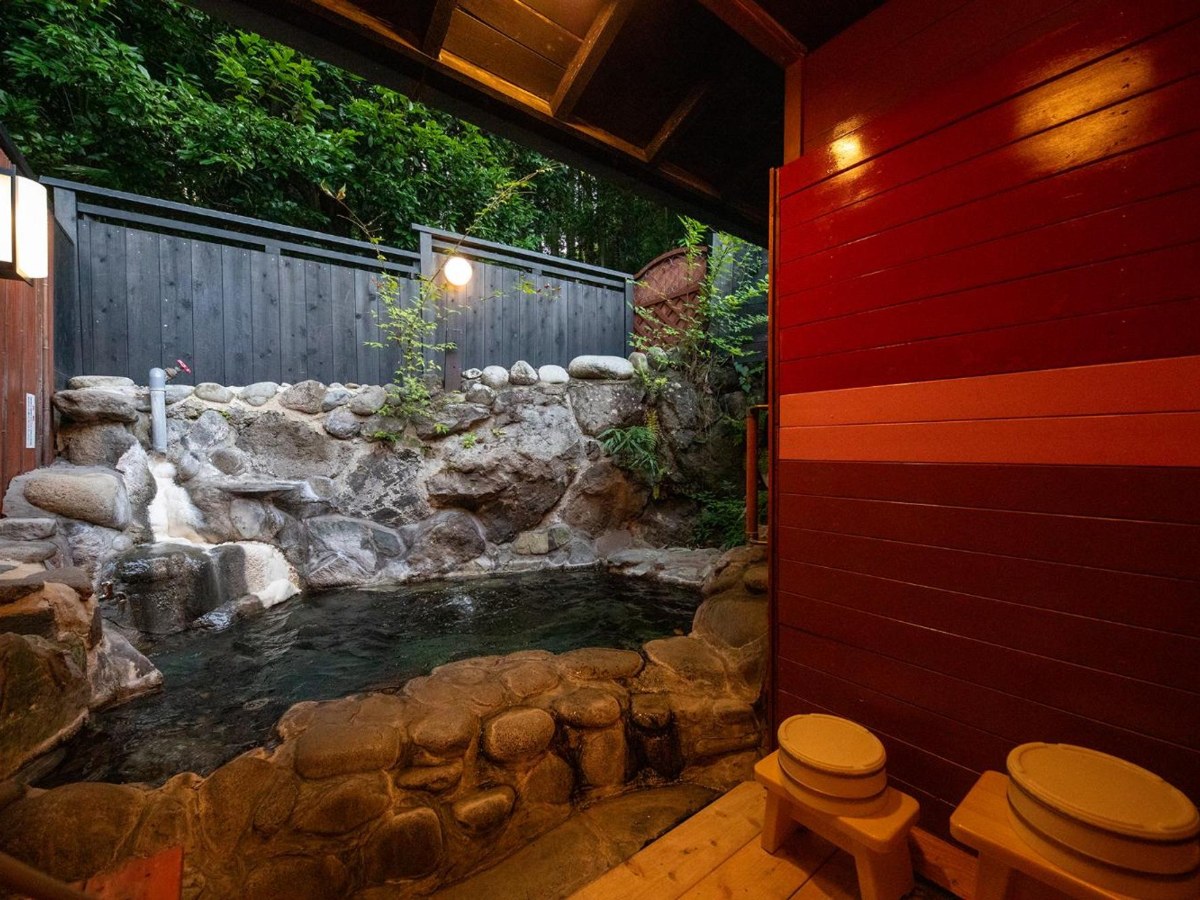 Rock open-air hot spring bath in the Family Room at Bessou Konjakuan