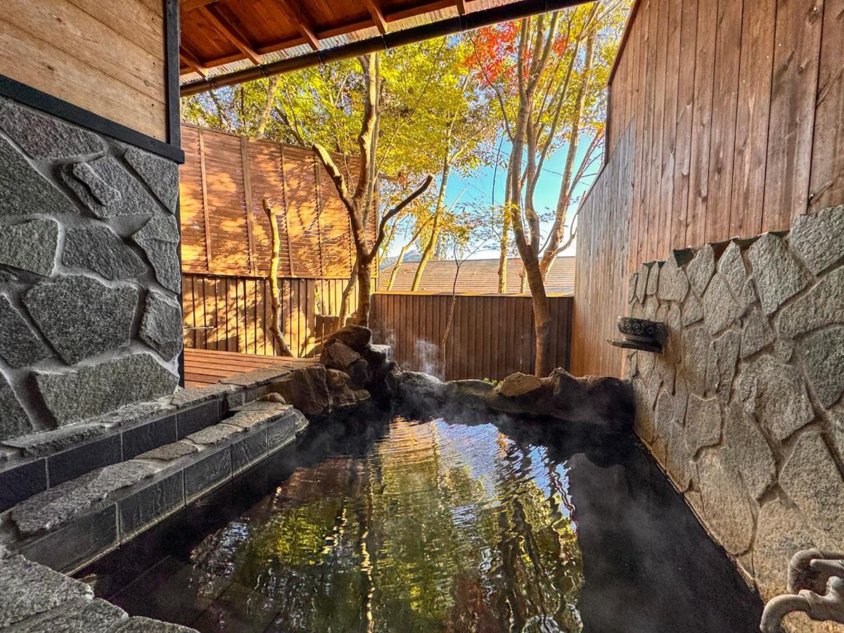 Stone open-air bath in the UMI room at Yufuin Ryokan Yufumomiji