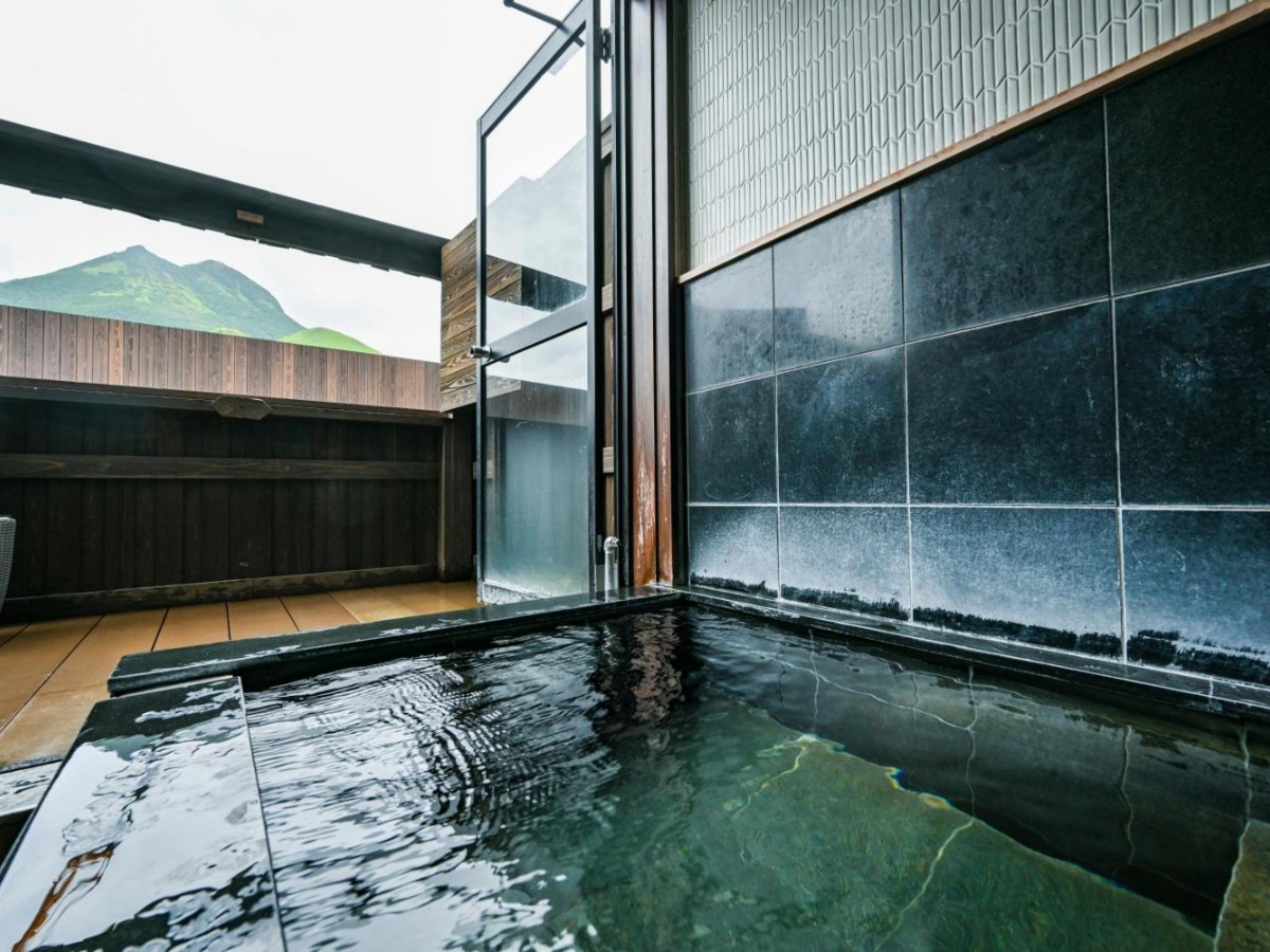 Semi-open-air hot spring bath in the Twin Room at Ryokan Yufusan